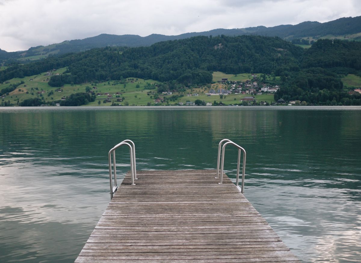 Badesteg am See mit Blick auf die umliegenden Berge